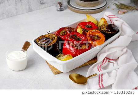 Greek traditional gemista, stuffed peppers with meat and rice in cooking dish 113310285