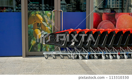 Row of shopping carts on summer street near store Row of shopping carts on summer street near store 113310330