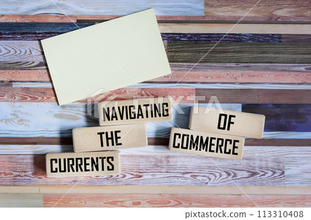 Wooden blocks with the message Navigating the flow of trade on a vintage background, space 113310408