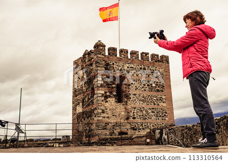 Tourist with camera on Sohail Castle in Fuengirola, Spain Tourist with camera on Sohail Castle in Fuengirola, Spain 113310564
