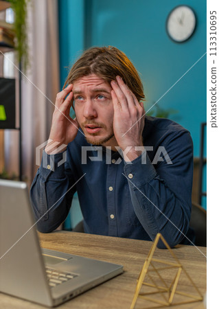 Tired ill businessman suffering from headache problem tension and migraine stress at home office 113310695