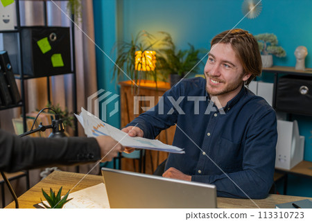 Business office man receiving documents from boss and working with financial graph calculate taxes 113310723