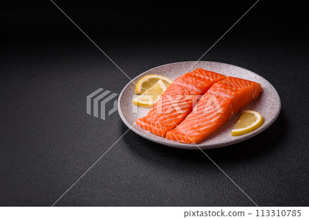 Fresh raw salmon steak with spices and herbs prepared for grilled baking Fresh raw salmon steak with spices and herbs prepared for grilled baking 113310785