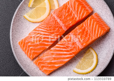 Fresh raw salmon steak with spices and herbs prepared for grilled baking Fresh raw salmon steak with spices and herbs prepared for grilled baking 113310789