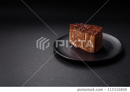Delicious fresh cheesecake cake or snickers with cream and nuts on a ceramic plate Delicious fresh cheesecake cake or snickers with cream and nuts on a ceramic plate 113310808
