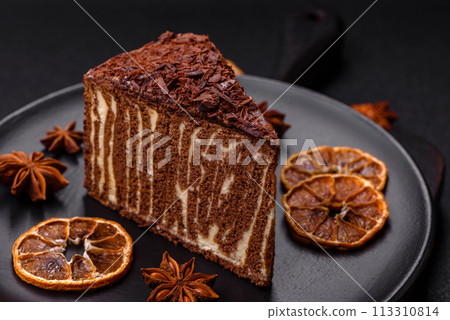 Delicious fresh cheesecake cake or snickers with cream and nuts on a ceramic plate 113310814