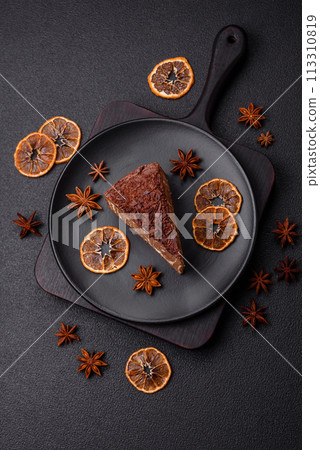 Delicious fresh cheesecake cake or snickers with cream and nuts on a ceramic plate Delicious fresh cheesecake cake or snickers with cream and nuts on a ceramic plate 113310819