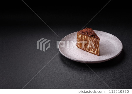 Delicious fresh cheesecake cake or snickers with cream and nuts on a ceramic plate Delicious fresh cheesecake cake or snickers with cream and nuts on a ceramic plate 113310820
