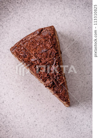 Delicious fresh cheesecake cake or snickers with cream and nuts on a ceramic plate Delicious fresh cheesecake cake or snickers with cream and nuts on a ceramic plate 113310825