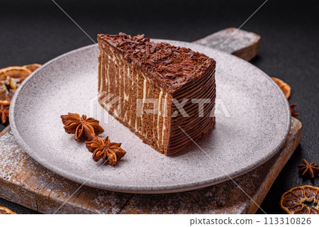Delicious fresh cheesecake cake or snickers with cream and nuts on a ceramic plate 113310826