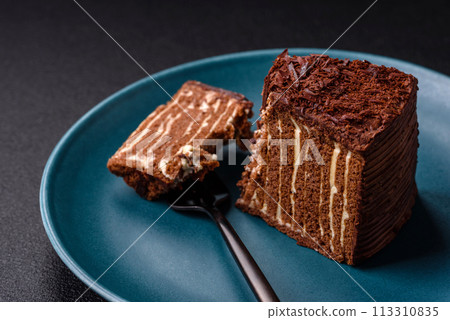 Delicious fresh cheesecake cake or snickers with cream and nuts on a ceramic plate Delicious fresh cheesecake cake or snickers with cream and nuts on a ceramic plate 113310835