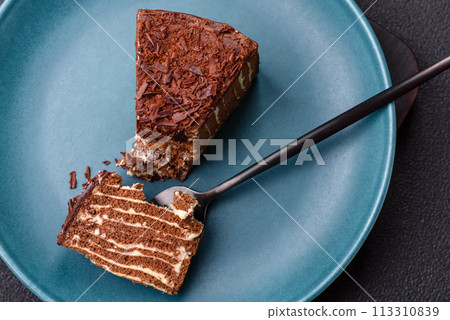 Delicious fresh cheesecake cake or snickers with cream and nuts on a ceramic plate 113310839