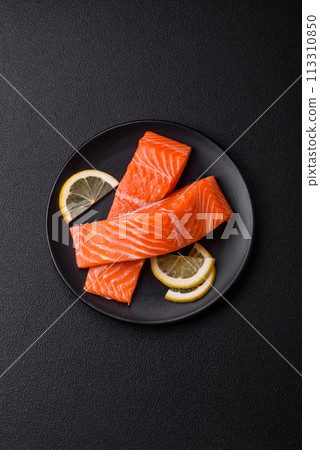 Fresh raw salmon steak with spices and herbs prepared for grilled baking Fresh raw salmon steak with spices and herbs prepared for grilled baking 113310850