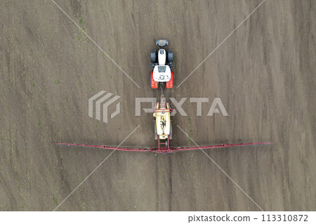 spraying grain on a field. 113310872