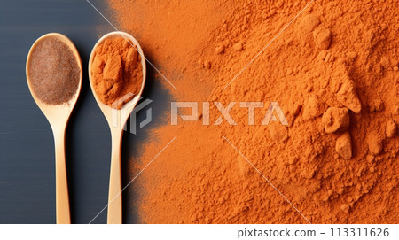 Organically Ground Paprika in Elegant Spoons with Vibrant Paprika Bunch 113311626
