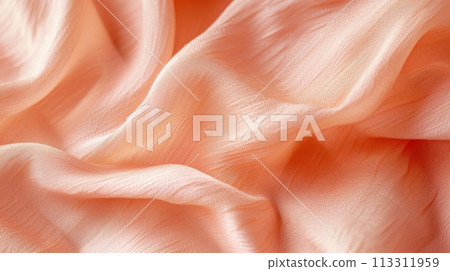 Close-up of delicate peach-colored fabric with soft folds. Luxury textile background. Close-up of delicate peach-colored fabric with soft folds. Luxury textile background. 113311959