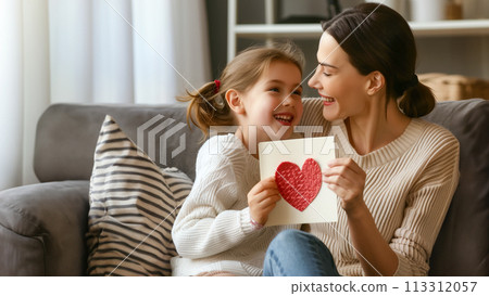 A tender moment between a smiling mother and her joyful daughter 113312057