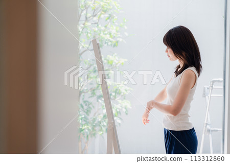 Young woman who is concerned about her figure Young woman who is concerned about her figure 113312860