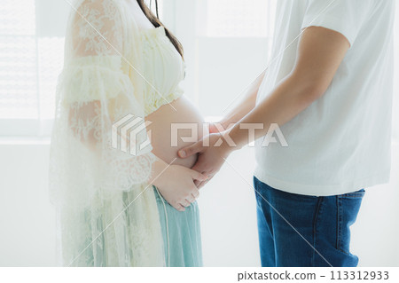 A husband supporting a pregnant woman A husband supporting a pregnant woman 113312933
