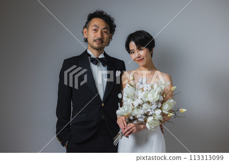 Woman in wedding dress and man in tuxedo 113313099