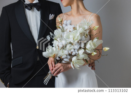 Woman in wedding dress and man in tuxedo Woman in wedding dress and man in tuxedo 113313102