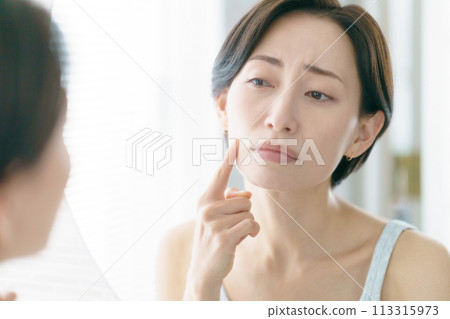 Middle-aged woman worried about skin care 113315973