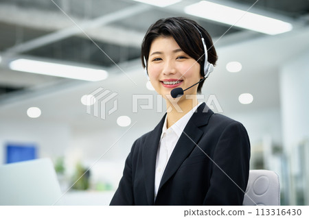 Young female operator wearing a headset in the office 113316430
