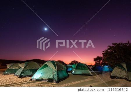 Full moon over a campsite Full moon over a campsite 113316842