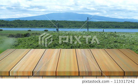 Empty wooden table with mountain background for a catering or food background with a country outdoor theme / Template mock up for display of product 113317242