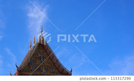 Blue sky and white clouds with sun beam over the buddhist temple roof in Thailand. Picture for use in Background image or copy space 113317290