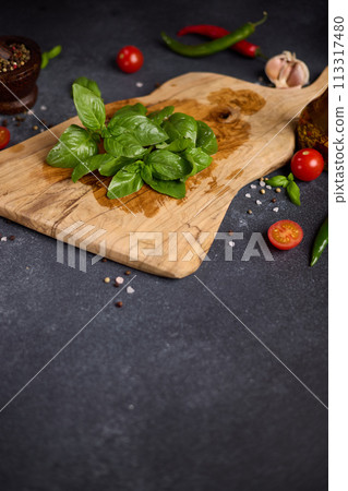 Green fresh Basil herb leaves on wooden cutting board Green fresh Basil herb leaves on wooden cutting board 113317480