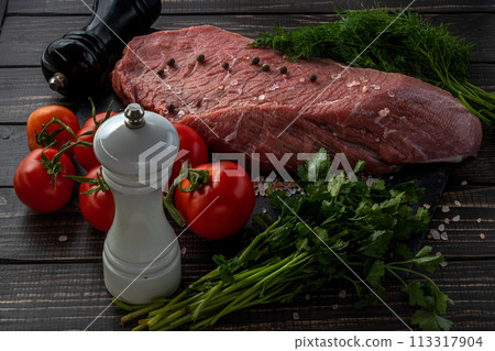Raw beef steak with spices on a dark slate, stoneselective focus Raw beef steak with spices on a dark slate, stoneselective focus 113317904