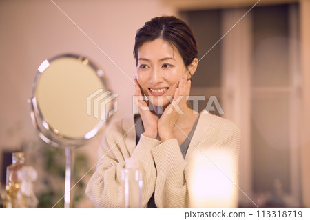Middle-aged woman doing night skin care 113318719