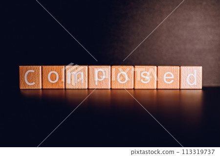 Wooden blocks form the text "Composed" against a black background. 113319737