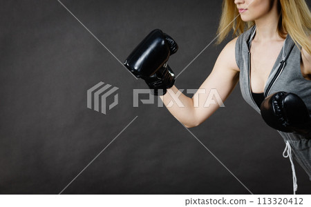 Woman wearing boxing gloves Woman wearing boxing gloves 113320412