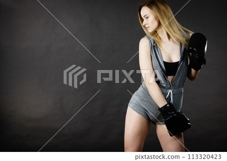 Woman wearing boxing gloves Woman wearing boxing gloves 113320423