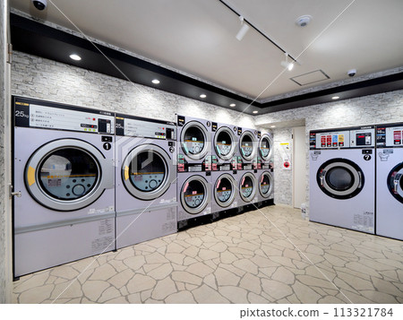 A laundromat with rows of washing machines 113321784