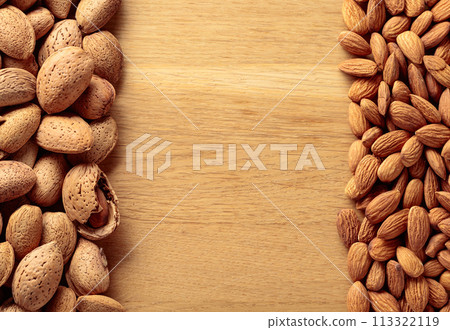 Almonds on a wooden background. Almonds on a wooden background. 113322119