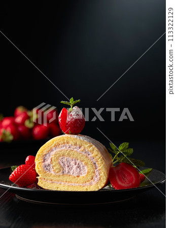 Delicious biscuit cake with strawberries on a black plate. 113322129