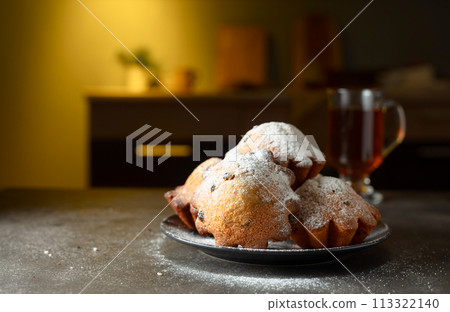 Homemade raisin cupcakes sprinkled with powdered sugar. Homemade raisin cupcakes sprinkled with powdered sugar. 113322140