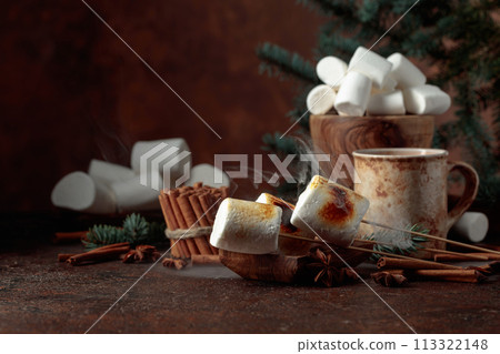 Toasted marshmallows on an old brown table. Toasted marshmallows on an old brown table. 113322148
