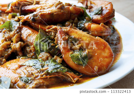 Asian food concept. Delicious Kam Heong Prawns on white plate. Asian food concept. Delicious Kam Heong Prawns on white plate. 113322413