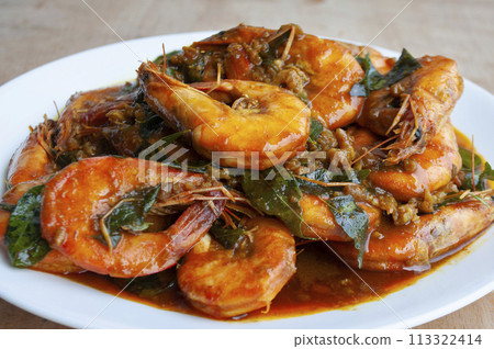 Serving Kam Heong Prawns on white plate. Delicious Asian food concept. 113322414