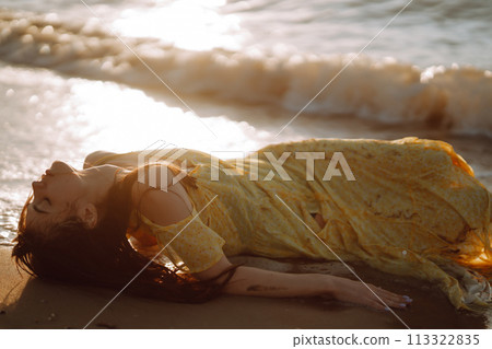Young woman walks along seashore at sunset. Nature, relax, lifestyle concept. 113322835