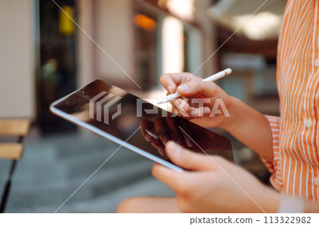 Male hand touching screen tablet close-up. Business, freelance, graphic concept. Male hand touching screen tablet close-up. Business, freelance, graphic concept. 113322982