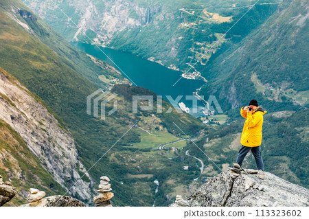 Tourist taking photo from Dalsnibba viewpoint Norway 113323602