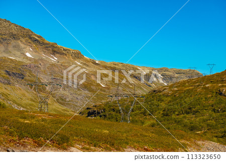 Power line voltage tower in mountains Power line voltage tower in mountains 113323650