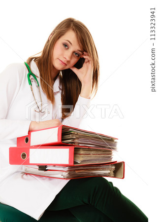 Paperwork. Overworked doctor woman with documents 113323941