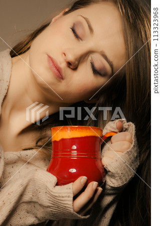Beverage. Girl holding cup mug of hot drink tea or coffee 113323968