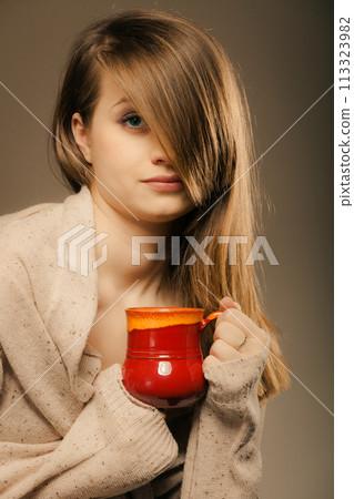 Beverage. Girl holding cup mug of hot drink tea or coffee Beverage. Girl holding cup mug of hot drink tea or coffee 113323982